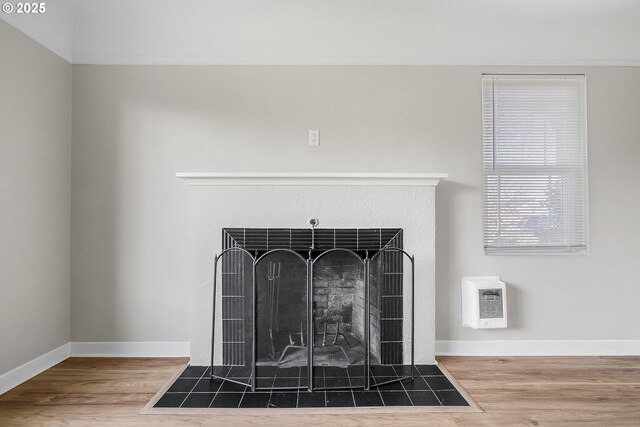 unfurnished room featuring heating unit and light hardwood / wood-style floors