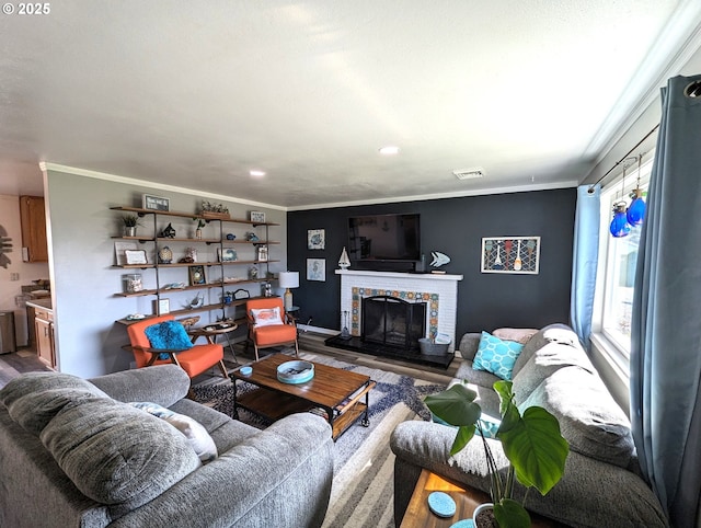 96335 Dawson Rd, Brookings, OR 97415 - living area with visible vents, a fireplace, wood finished floors, ornamental molding, and recessed lighting