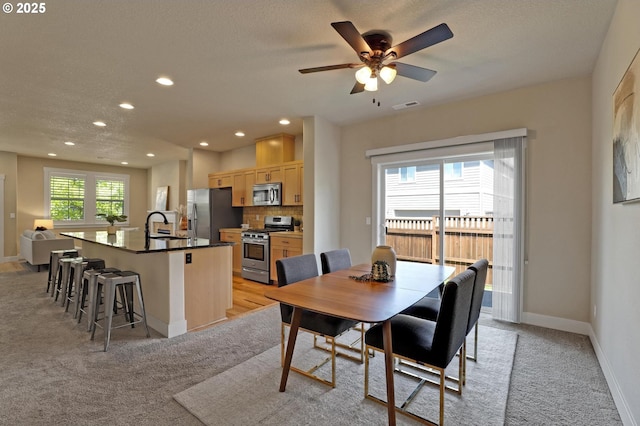 dining space with recessed lighting, light carpet, baseboards, a ceiling fan, and a textured ceiling