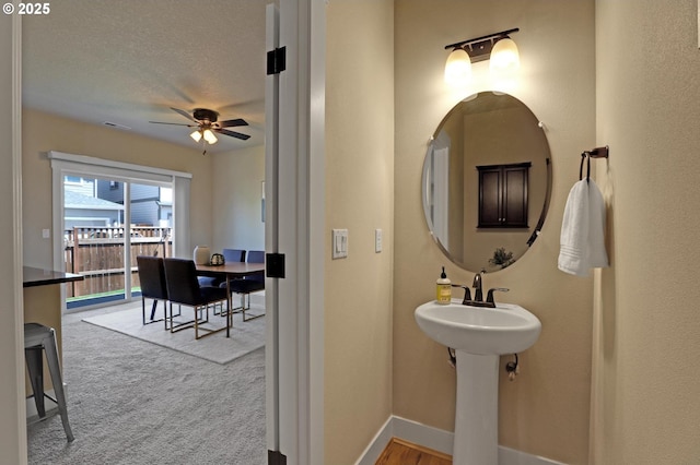 bathroom featuring a ceiling fan and baseboards
