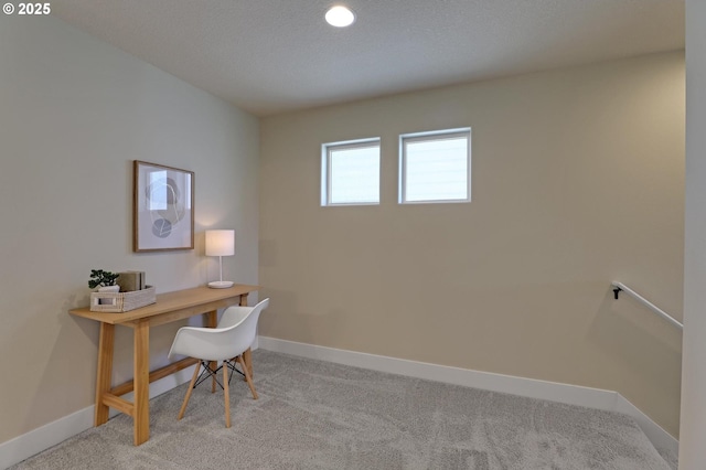office area with baseboards and light carpet