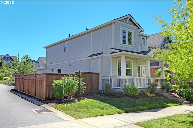 view of side of property with covered porch