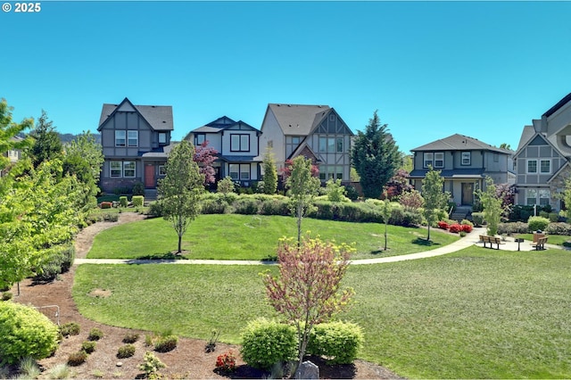 view of property's community featuring a residential view and a yard