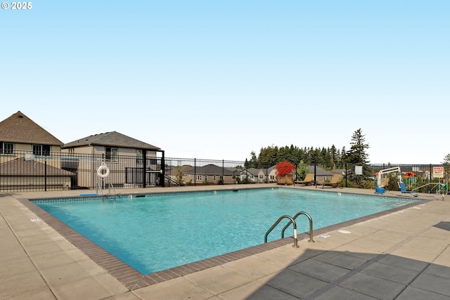 community pool featuring fence and a patio