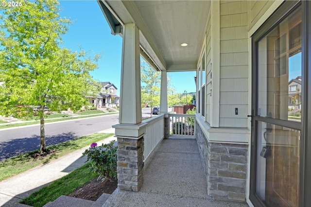 view of patio / terrace featuring covered porch and a residential view