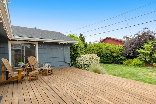wooden deck featuring a lawn
