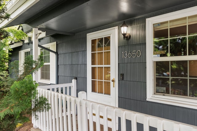 view of exterior entry featuring covered porch