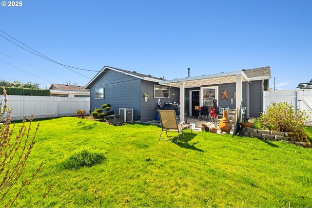 back of house with a yard, a fenced backyard, cooling unit, and a patio area