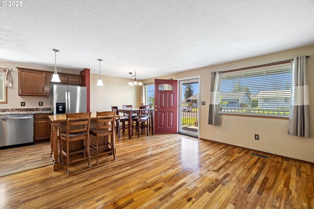 kitchen with plenty of natural light, light wood-style floors, visible vents, and appliances with stainless steel finishes
