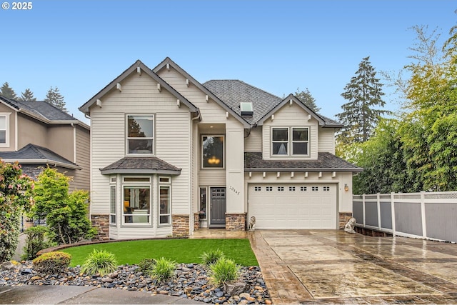 10445 SW 141st Ave, Beaverton, OR 97008 - craftsman-style home featuring concrete driveway, an attached garage, stone siding, and a shingled roof