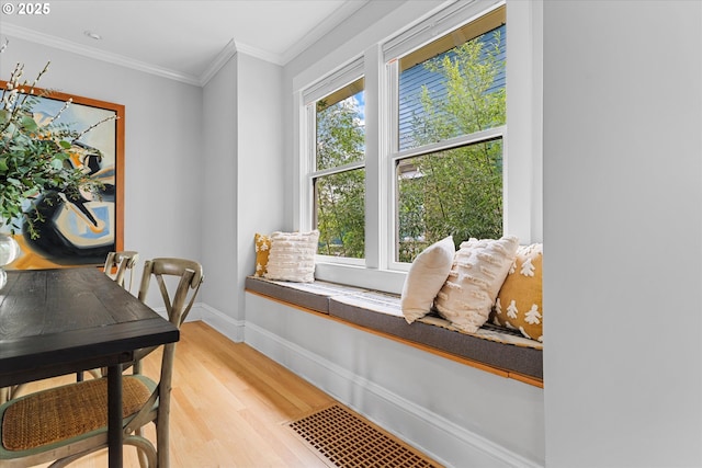 office area featuring light wood-style floors, baseboards, and crown molding
