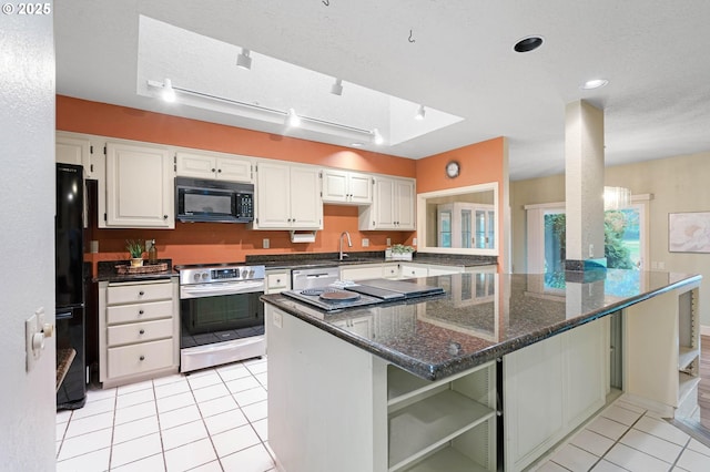 kitchen featuring black appliances, white cabinets, light tile patterned floors, and dark stone countertops