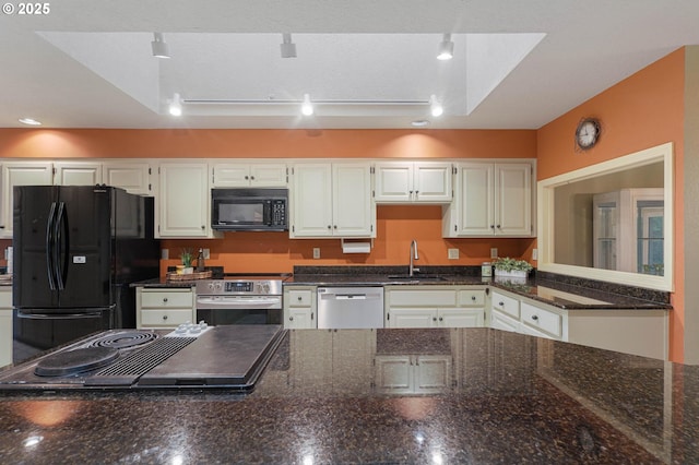 kitchen with black appliances, white cabinets, sink, and track lighting