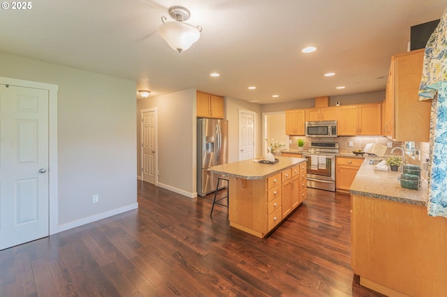 29115 NE 99th Ave, Battle Ground, WA 98604 - kitchen with appliances with stainless steel finishes, light brown cabinets, a kitchen island, dark wood-style flooring, and recessed lighting