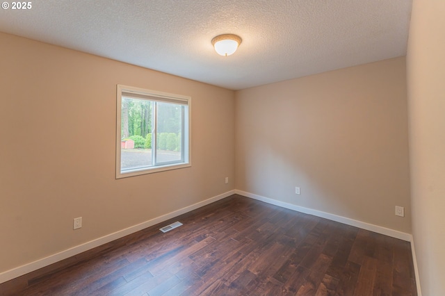 29115 NE 99th Ave, Battle Ground, WA 98604 - spare room with dark wood-style flooring, baseboards, and a textured ceiling
