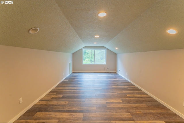 29115 NE 99th Ave, Battle Ground, WA 98604 - bonus room featuring a textured ceiling, dark wood-type flooring, baseboards, lofted ceiling, and recessed lighting