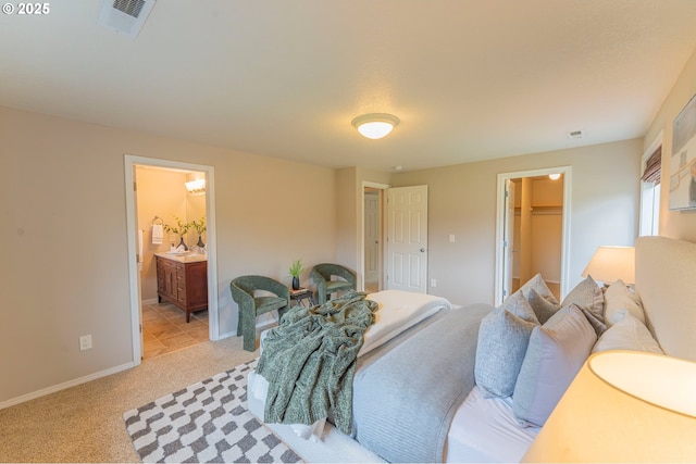 29115 NE 99th Ave, Battle Ground, WA 98604 - bedroom with light carpet, a walk in closet, baseboards, ensuite bathroom, and a closet