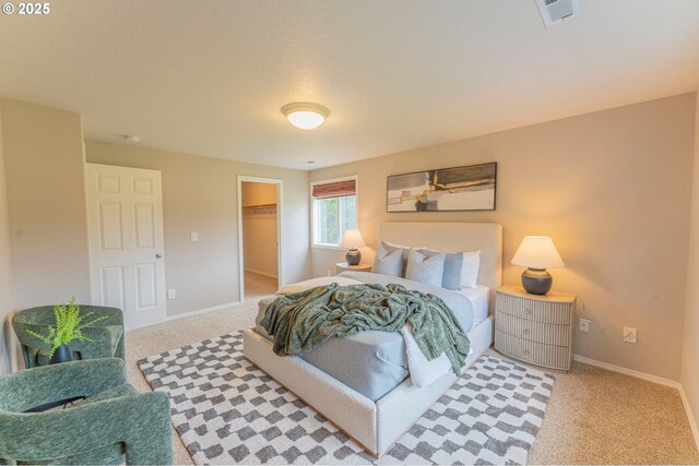 29115 NE 99th Ave, Battle Ground, WA 98604 - bedroom with carpet floors, baseboards, a spacious closet, and a textured ceiling