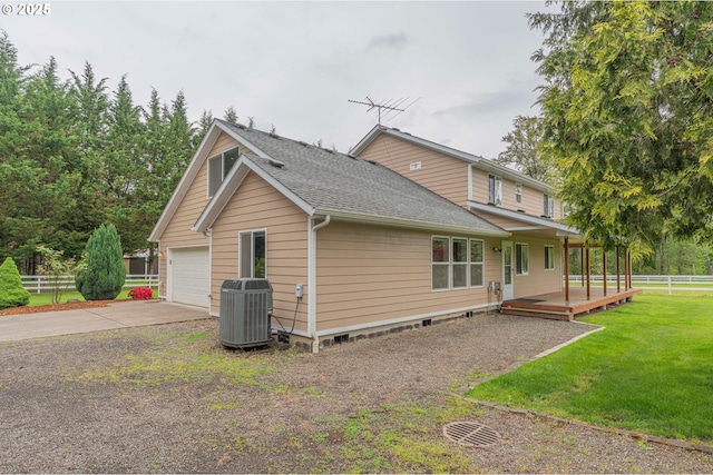 29115 NE 99th Ave, Battle Ground, WA 98604 - view of home's exterior with central AC unit, roof with shingles, concrete driveway, an attached garage, and a wooden deck