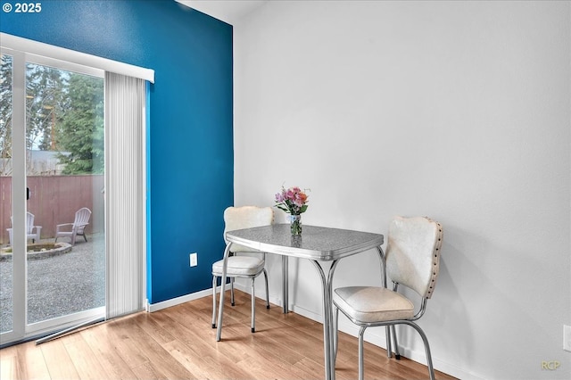 dining area featuring baseboards and wood finished floors