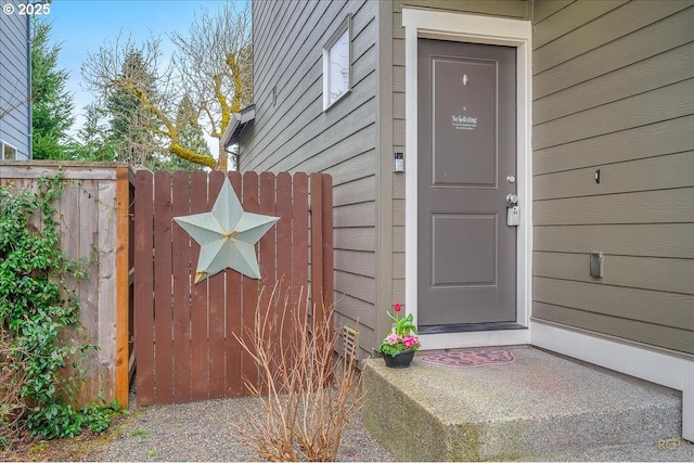 doorway to property with a gate and fence