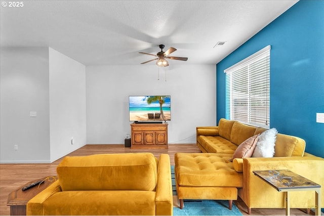 living room featuring ceiling fan, wood finished floors, and visible vents