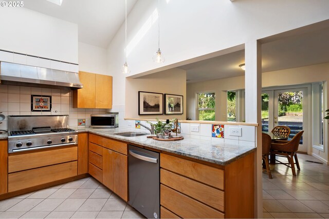2941 SW Moss St, Portland, OR 97219 - kitchen with stainless steel appliances, light tile patterned flooring, a sink, and tasteful backsplash