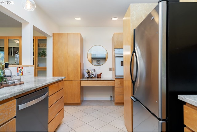 2941 SW Moss St, Portland, OR 97219 - kitchen featuring stainless steel appliances, modern cabinets, light stone countertops, light tile patterned flooring, and recessed lighting