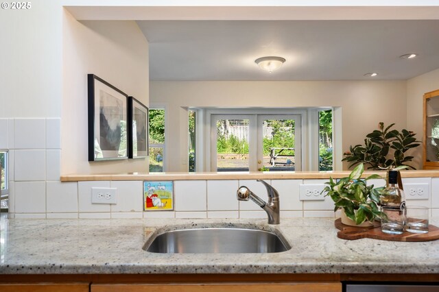 2941 SW Moss St, Portland, OR 97219 - kitchen with a sink, light stone countertops, and backsplash