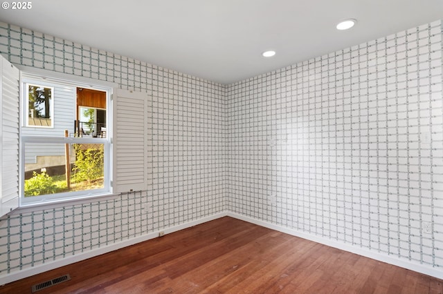 2941 SW Moss St, Portland, OR 97219 - unfurnished room with hardwood / wood-style floors, wallpapered walls, recessed lighting, and baseboards
