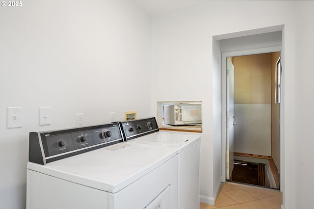 2941 SW Moss St, Portland, OR 97219 - laundry area with washer and dryer and light tile patterned flooring