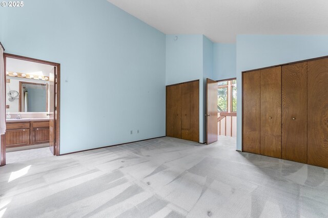 2 Icarus Loop, Lake Oswego, OR 97035 - unfurnished bedroom with high vaulted ceiling, light colored carpet, and ensuite bath