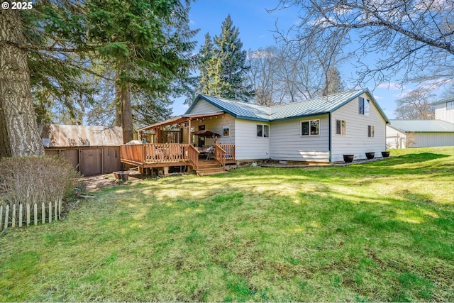 back of property with a wooden deck and a yard