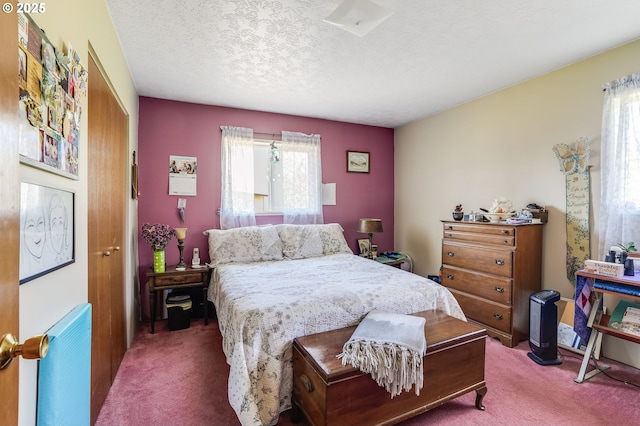 bedroom featuring carpet and a textured ceiling