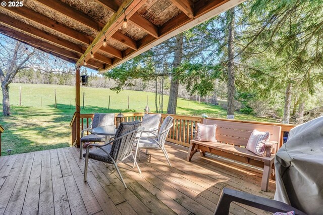 wooden deck with a grill and a yard