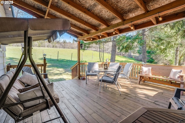 wooden terrace featuring a lawn