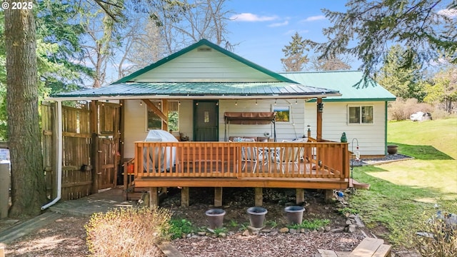 back of house with a yard and a deck