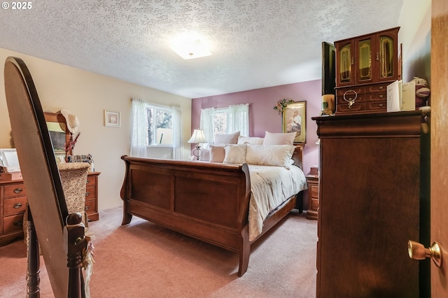 bedroom with light carpet and a textured ceiling