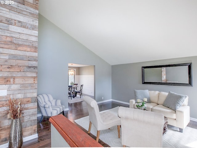 living area with baseboards, dark wood-style flooring, and high vaulted ceiling