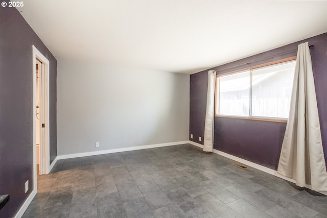 unfurnished room featuring baseboards