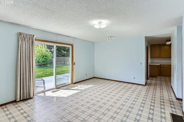 13230 SW Hill Ct, Portland, OR 97223 - unfurnished room with baseboards, visible vents, and a textured ceiling