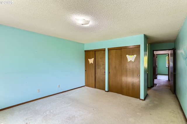 13230 SW Hill Ct, Portland, OR 97223 - unfurnished bedroom with carpet, two closets, and a textured ceiling