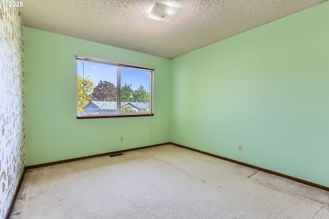 13230 SW Hill Ct, Portland, OR 97223 - carpeted spare room with a textured ceiling, visible vents, and baseboards