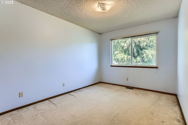 13230 SW Hill Ct, Portland, OR 97223 - unfurnished room with light colored carpet, a textured ceiling, baseboards, and visible vents