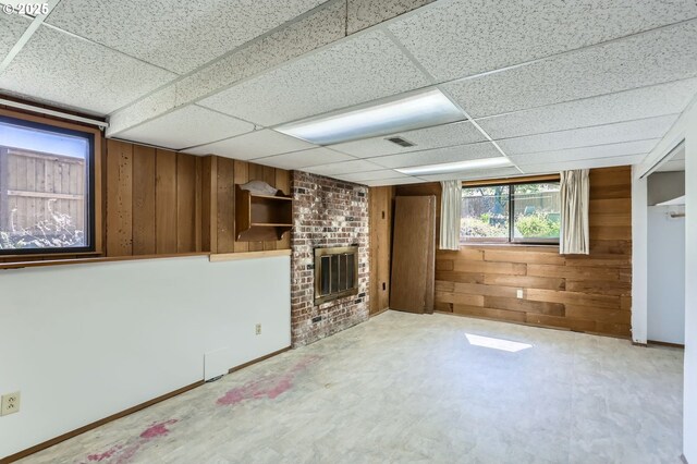 13230 SW Hill Ct, Portland, OR 97223 - unfurnished living room featuring a fireplace, wooden walls, and a drop ceiling