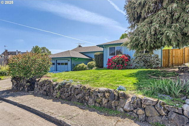 13230 SW Hill Ct, Portland, OR 97223 - view of front facade featuring fence, an attached garage, and a front yard