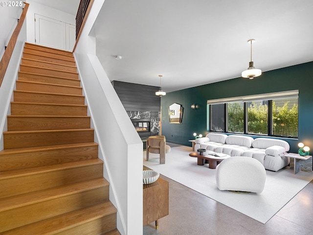 4566 NE Cesar E Chavez Blvd, Portland, OR 97211 - living room with a fireplace, stairs, and an accent wall