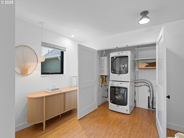 4566 NE Cesar E Chavez Blvd, Portland, OR 97211 - washroom with stacked washer / dryer, light wood-style flooring, water heater, and recessed lighting