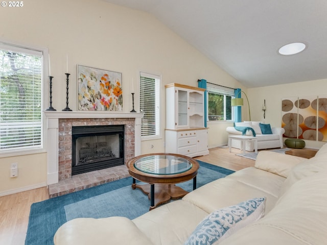 1761 SW Songbird St, Mcminnville, OR 97128 - living area with vaulted ceiling, wood finished floors, a brick fireplace, and baseboards