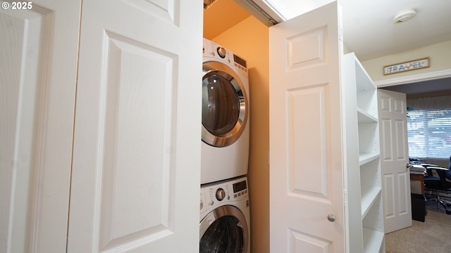 laundry room featuring stacked washer and clothes dryer